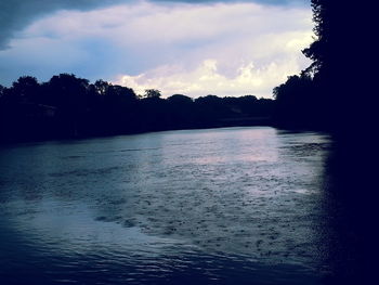 Scenic view of river at sunset