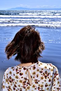 Rear view of woman looking at sea shore