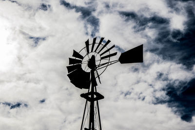 Low angle view of windmill against cloudy sky