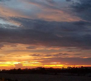 Scenic view of dramatic sky during sunset