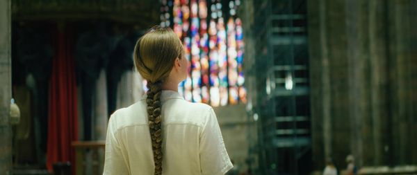 Side view of woman standing in city