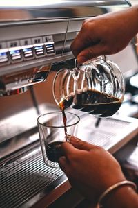 Cropped image of man pouring coffee in cup