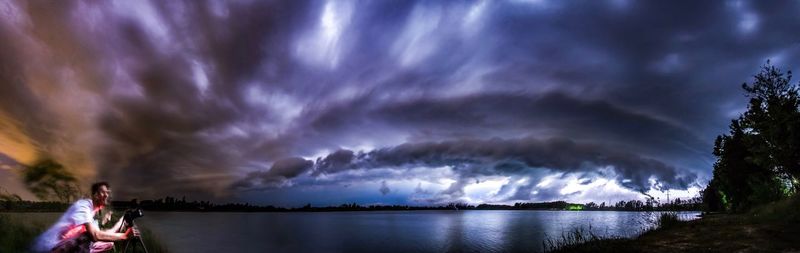 Panoramic view of storm clouds over lake at night