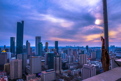 High angle view of cityscape against cloudy sky during sunset