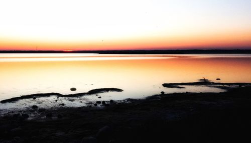 Scenic view of beach against sky during sunset