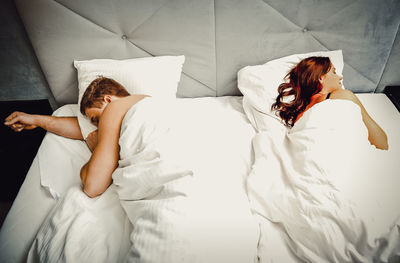 High angle view of woman lying on bed