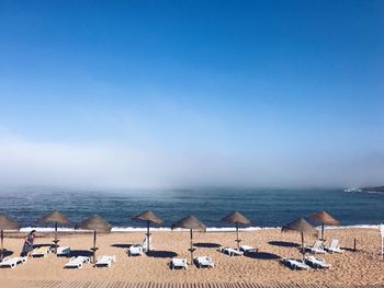 Scenic view of beach against blue sky