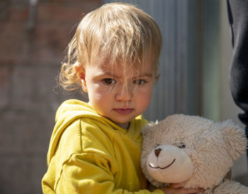 Portrait of cute boy with toy