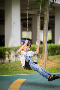 Full length of boy enjoying swing