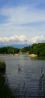 Scenic view of calm lake against cloudy sky