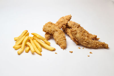 High angle view of bread and meat on white background