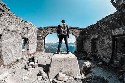 Low angle view of man standing in abandoned building