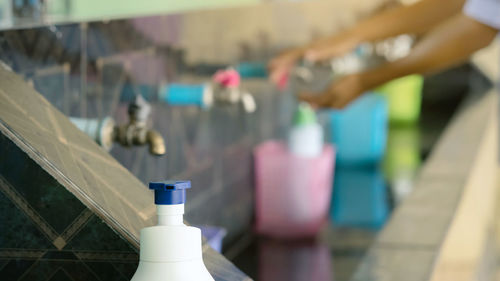 Close-up of wine bottles on railing