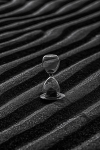 Close-up of hourglass on sand