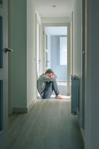 Rear view of woman standing in room