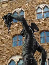 Low angle view of statue against building