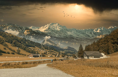 Scenic view of snowcapped mountains against sky during sunset