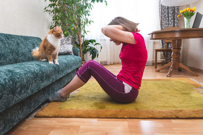 Woman sitting on floor at home