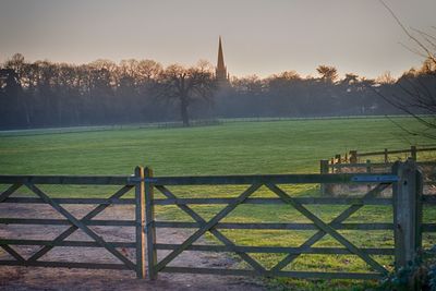 Fence on field against sky