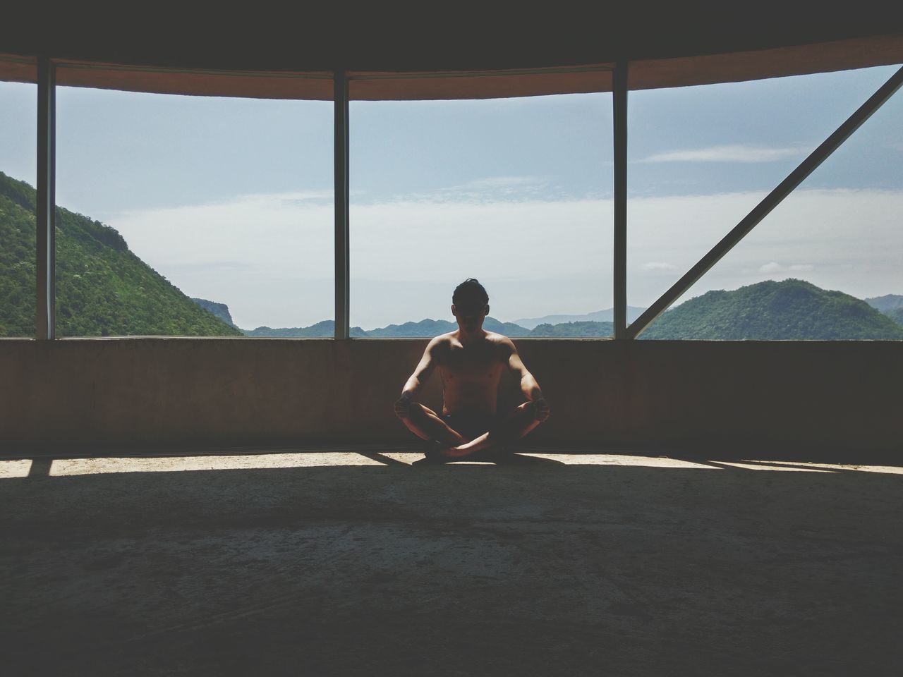 full length, lifestyles, sky, indoors, leisure activity, rear view, window, sitting, standing, casual clothing, day, cloud - sky, railing, sea, men, childhood, side view, built structure