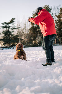 Man with dog on snow