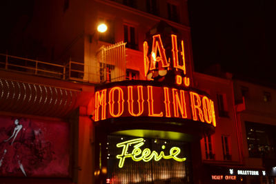 Low angle view of illuminated sign at night