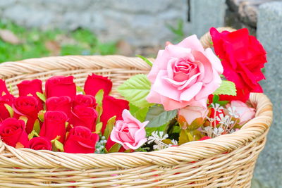 Artificial roses in wicker basket