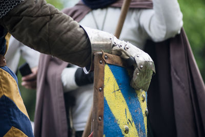 Midsection of people in costume with shield