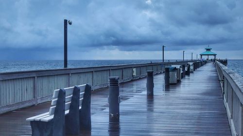 Pier over sea against the stormy sky