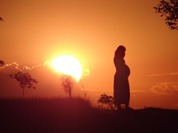 Silhouette of woman at sunset