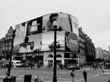 People on city street against clear sky