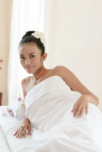 Portrait of young woman relaxing at spa