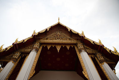 Low angle view of temple and building against sky