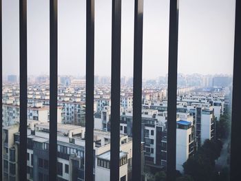 Buildings in city seen from railing