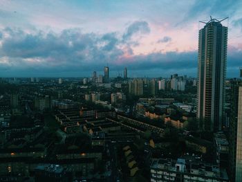 Aerial view of buildings in city against sky