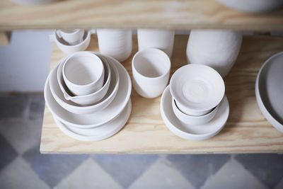 High angle view of earthenware on shelf