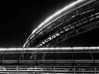 Low angle view of illuminated bridge against clear sky at night