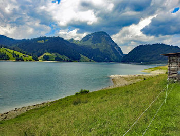 Scenic view of lake and mountains against sky