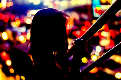 Close-up of man playing music at night