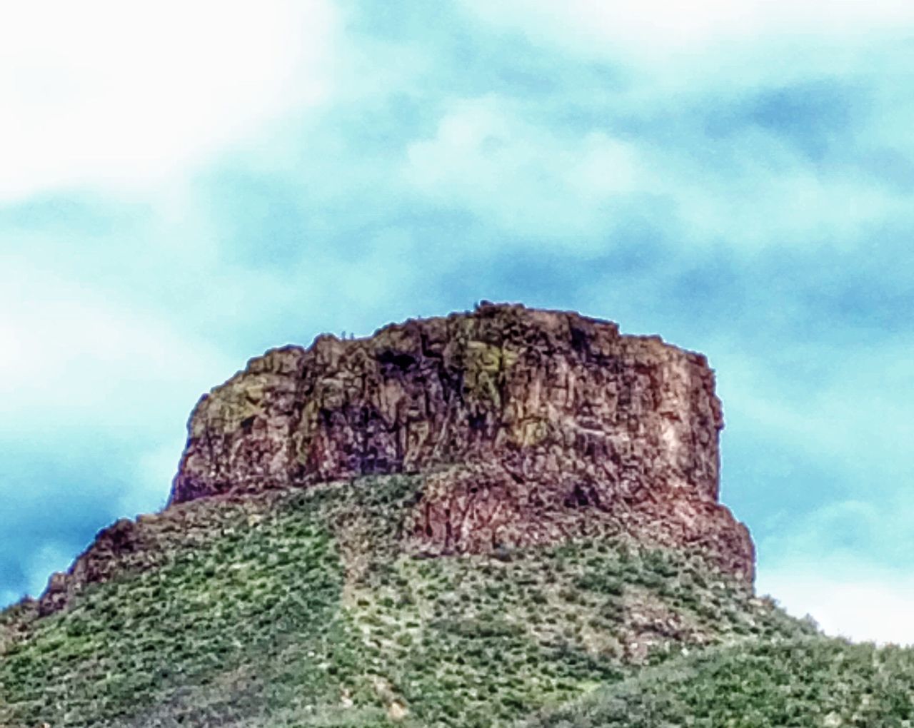 sky, cloud - sky, rock - object, low angle view, rock formation, tranquility, cloud, nature, tranquil scene, cloudy, scenics, rock, beauty in nature, day, cliff, stone, landscape, textured, outdoors, stone wall