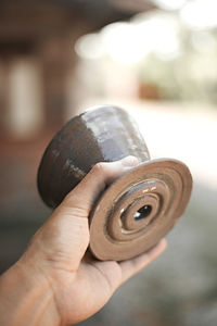 Close-up of hand holding metal