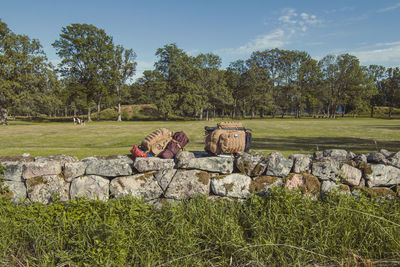 Tourist rucksacks on stone fence landscape photo