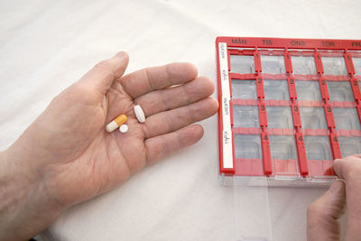 Close-up of person taking various medications