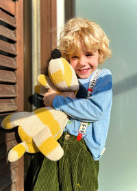 Portrait of a boy hugging his stuffed animal