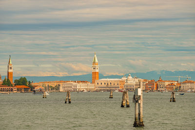 View of building by sea against cloudy sky