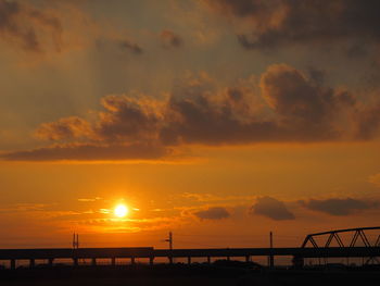 Silhouette bridge against sky during sunset