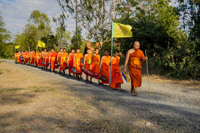 Rear view of people walking on road