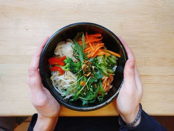 High angle view of woman holding bowl