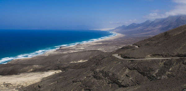 Scenic view of sea against blue sky