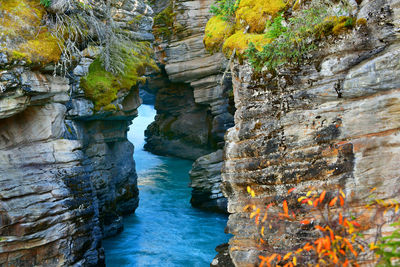 Scenic view of rock formation by river